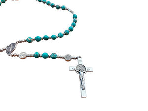 During her evening meditation on Nov. 27, 1830, Catherine has a vision of Mary standing in a position similar to the depiction on the medal. Later, the vision changes to include the inscription found on the front side of the medal. Mary speaks to Catherine, saying, "Have a medal struck upon this model. Those who wear it will receive great graces, especially if they wear it around their neck."